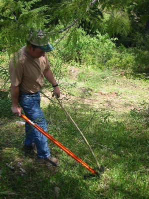 Push the Extractigator handle to the ground to uproot the plant The Extractigator is works great with removing unwanted brush